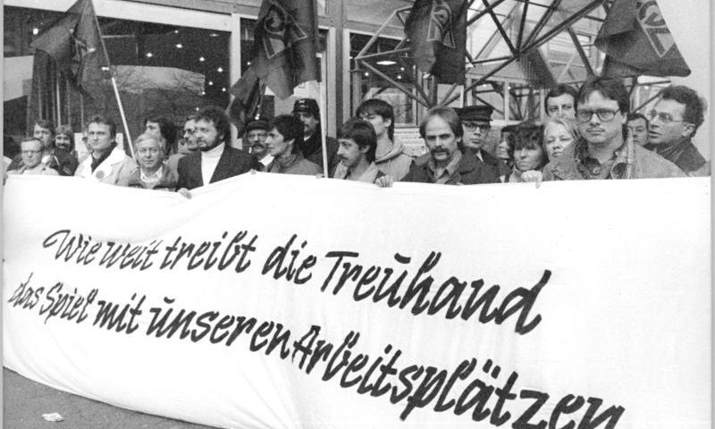 Stahlarbeiter protestieren 1990 vor dem Gebäude der Treuhand