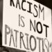 Protestschild "Racism is not Patriotism"