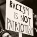 Protestschild "Racism is not Patriotism"