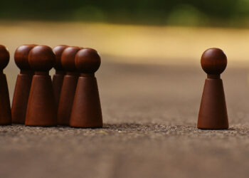 Braune Spielfiguren: Einer gegen eine Gruppe